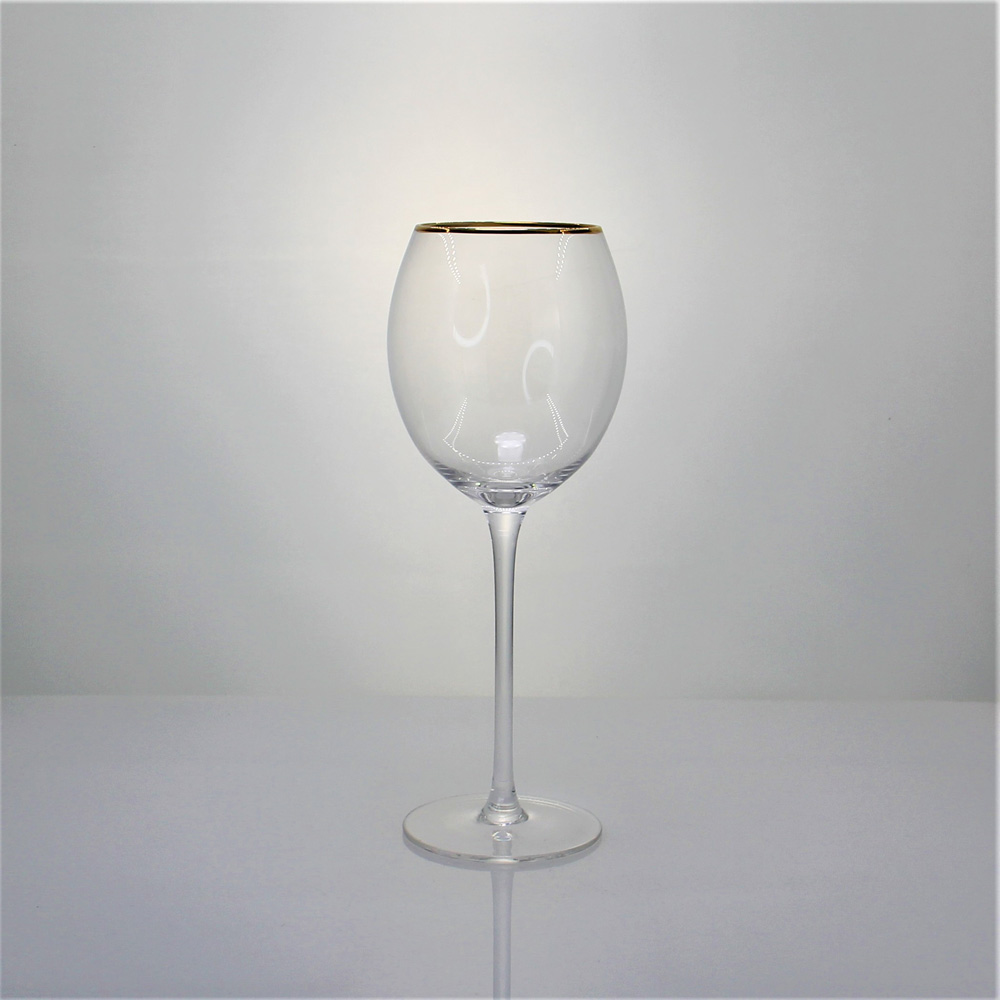 Gold rimmed red wine glass